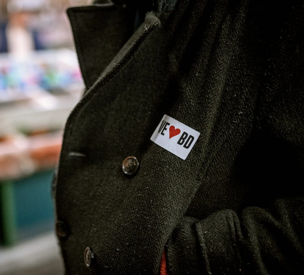A coat with a sticker reading 'I heart BD'