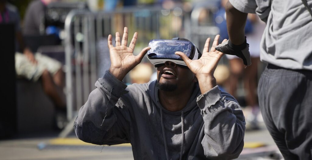 A man wearing a VR headset crouching and looking to the sky