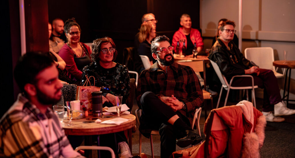 Group of people sat listening to a speaker off camera at an event at Common Space to illustrate WYCreate Masterclasses