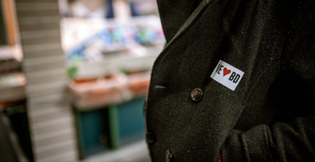 Close of up of a wool jacket with a sticker that says I heart Bradford